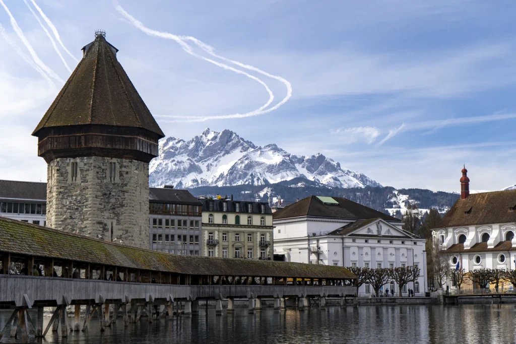 In Luzern die historischen Bauten umgeben von Wasser und Natur genießen mit Bergen im Hintergrund.
